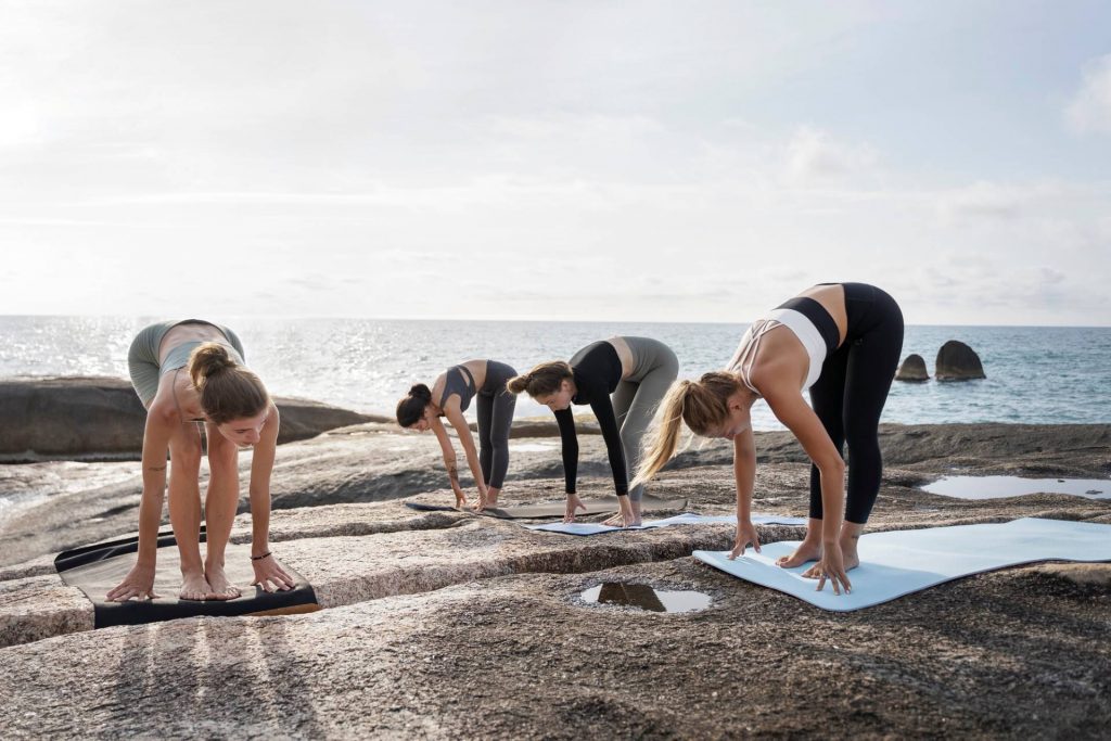 Introducing New Health & Diabetes Reversal Retreats 1 full shot women exercising yoga mat seaside Custom